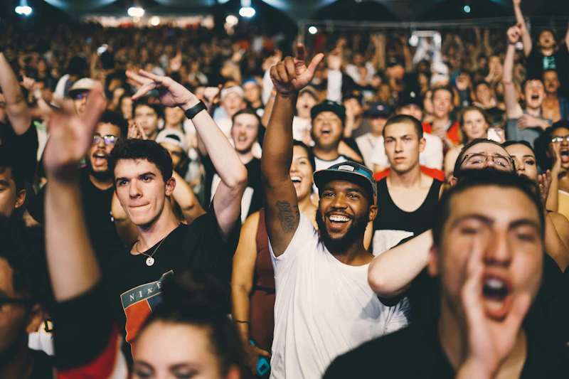 Concert audience under stage lights at an indoor venue